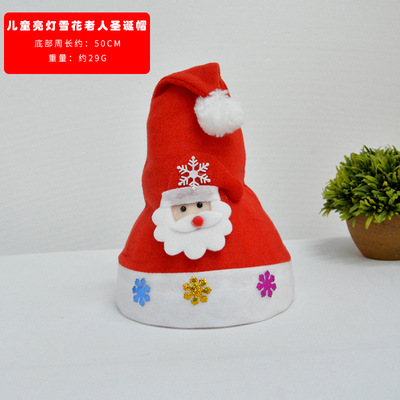 子供が明かりをともす雪の華老人のクリスマス帽子